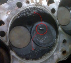 Kondolay cylinder head damage (arrows) caused by a chunk of 1/8" allen key (circled)